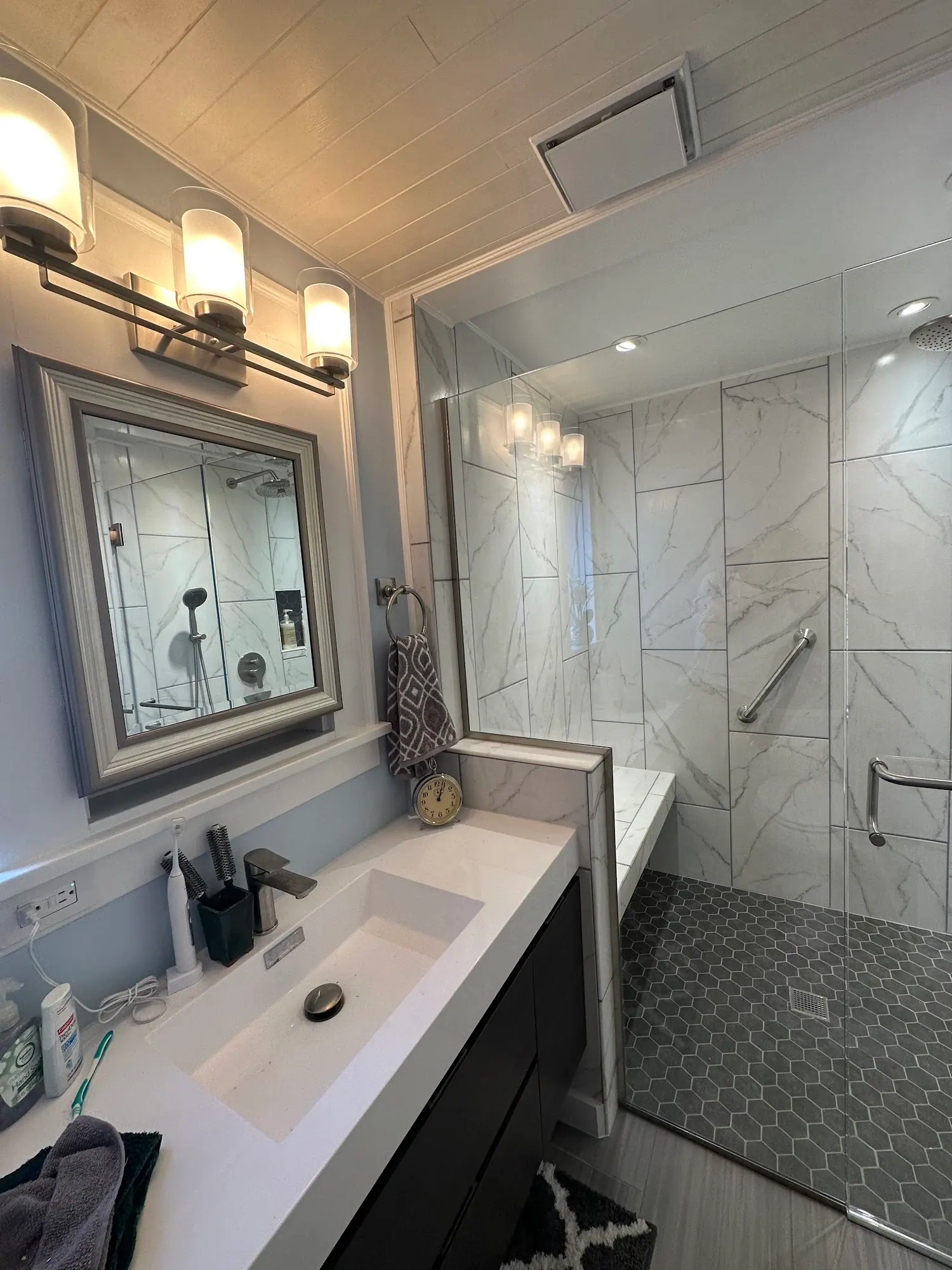Bathroom with a vanity, mirror and tiled shower